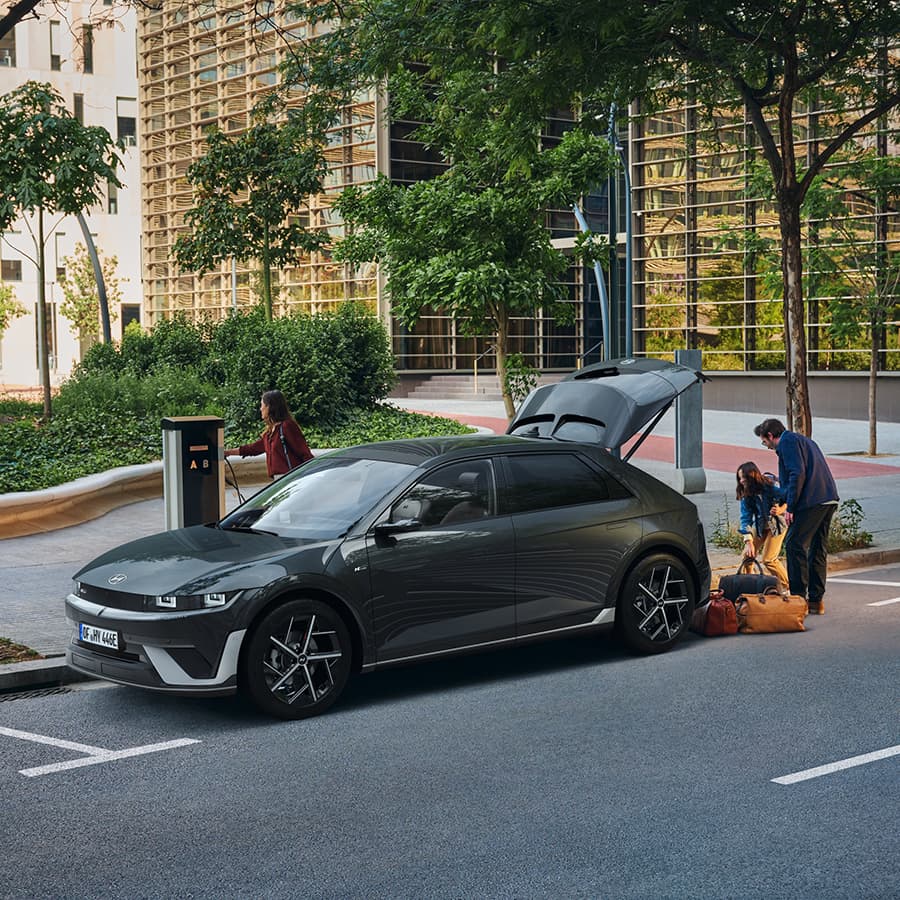 Hyundai IONIQ 5 parked charging at a public EV charging station.