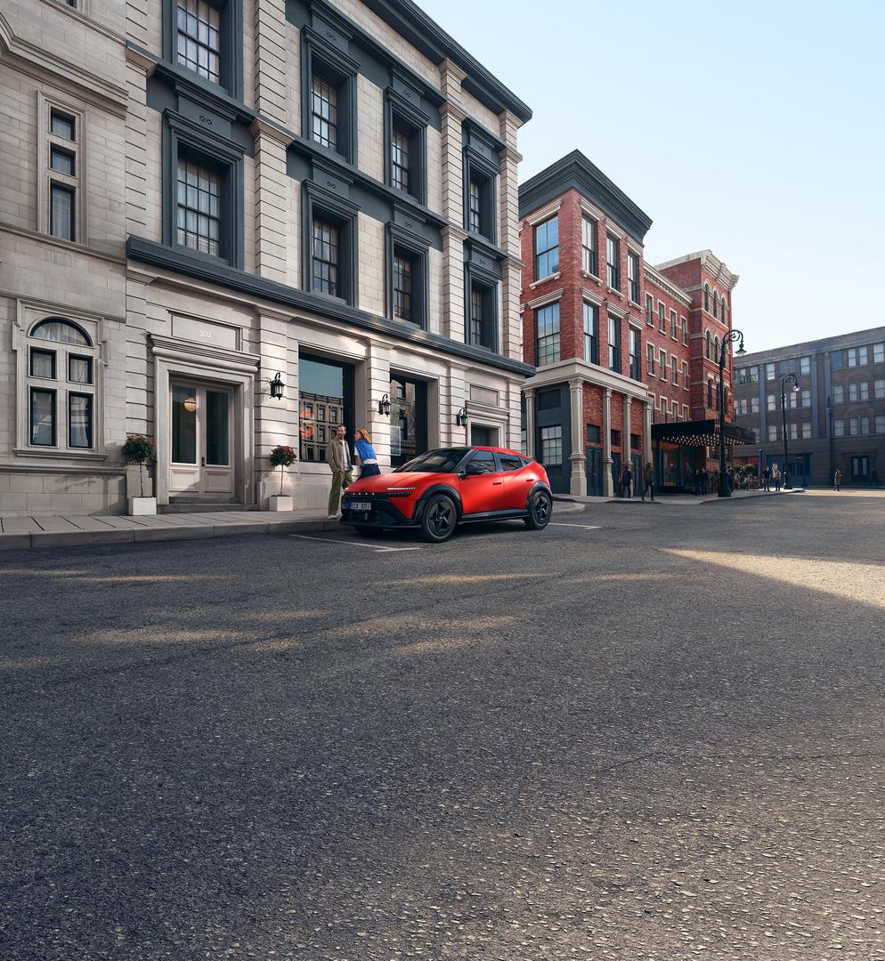 Red Hyundai IONIQ 3 parked on an urban street, shown from a front three-quarter angle view design.