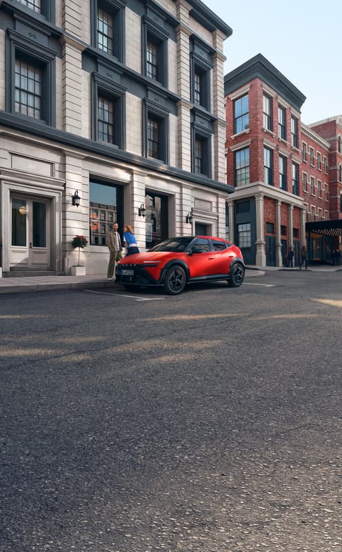 Ein roter Hyundai IONIQ 3, der auf einer Stadtstraße geparkt ist, dargestellt aus einer vorderen Dreiviertelansicht.