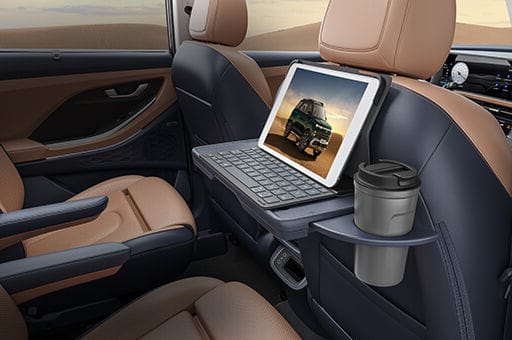 Front row seatback table with IT device holder