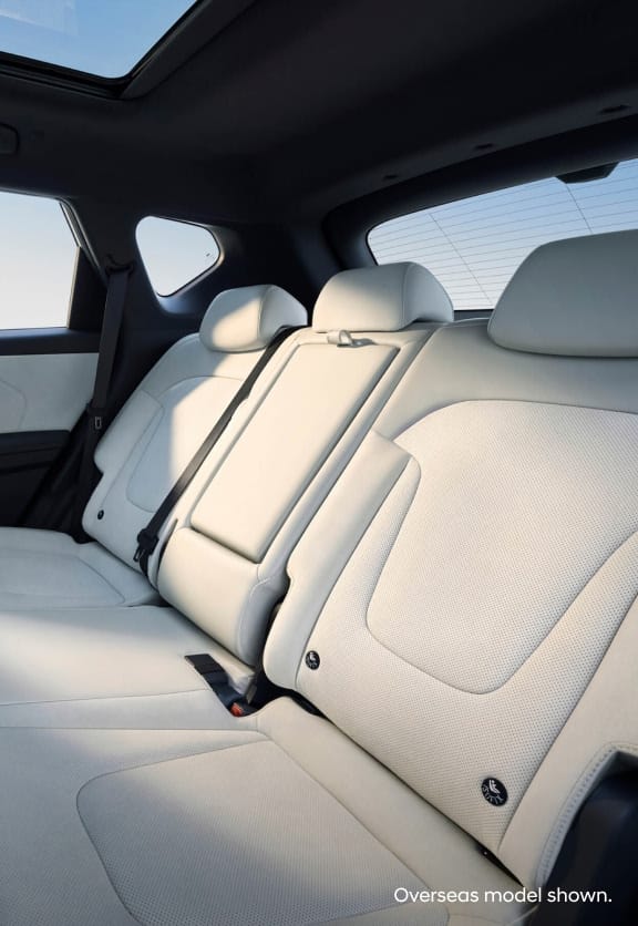 Hyundai Elexio rear seat design with light leather trim, panoramic sunroof, and foldable armrest—crafted for comfort and modern elegance