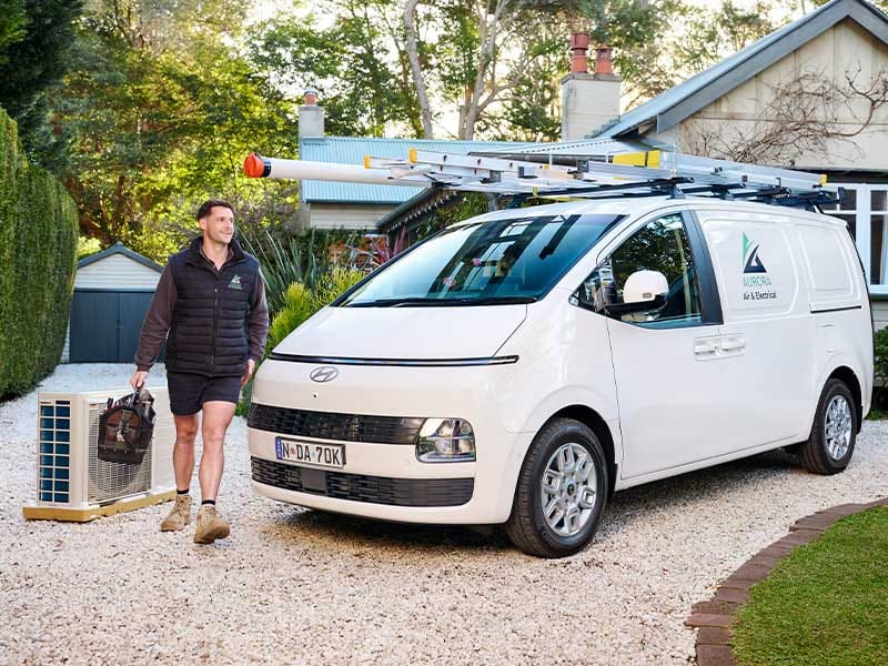 Electrician arriving at a residential property in a Hyundai STARIA Load, showcasing practical fleet solutions for Australian businesses.