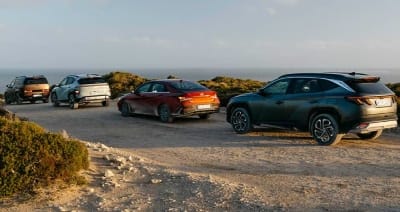 Hyundai SANTA FE Hybrid, KONA Hybrid, and i30 Sedan Hybrid explore a rugged coastal trail with ocean views highlighting versatile design, hybrid efficiency, and adventurous spirit in a scenic lifestyle setting.