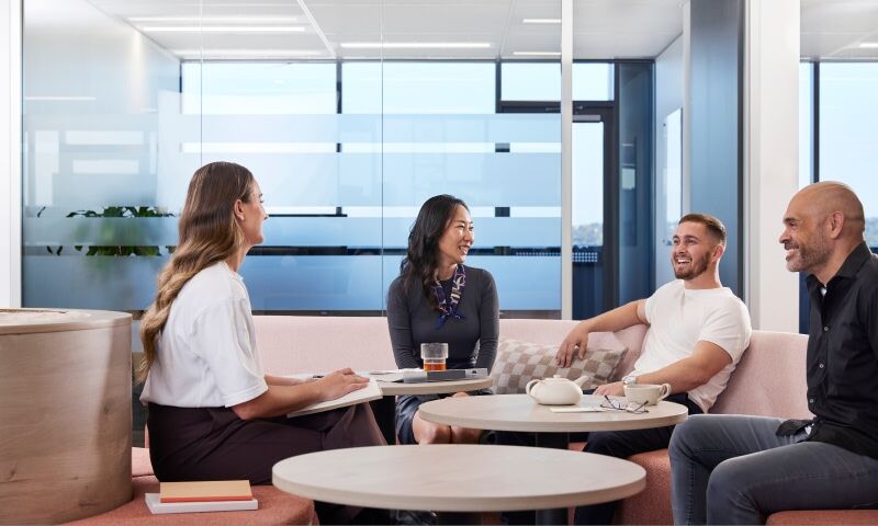 The hyundai team members are conversing cheerfully, exchanging laughter and positive energy.
