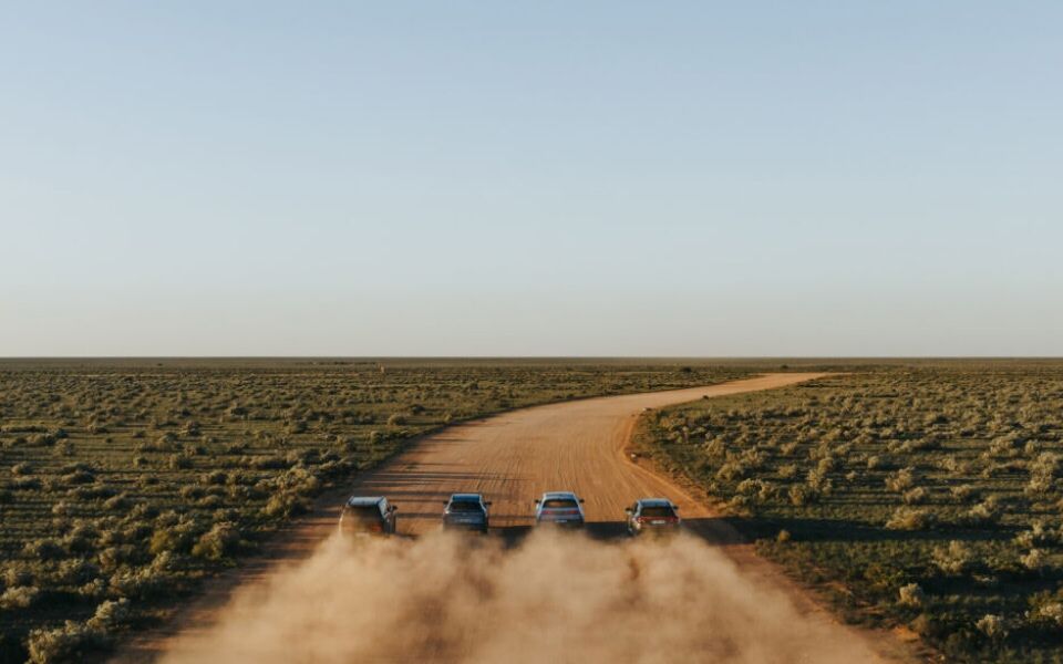 The rear view of hyundai N cars line dup against a desert backdrop.