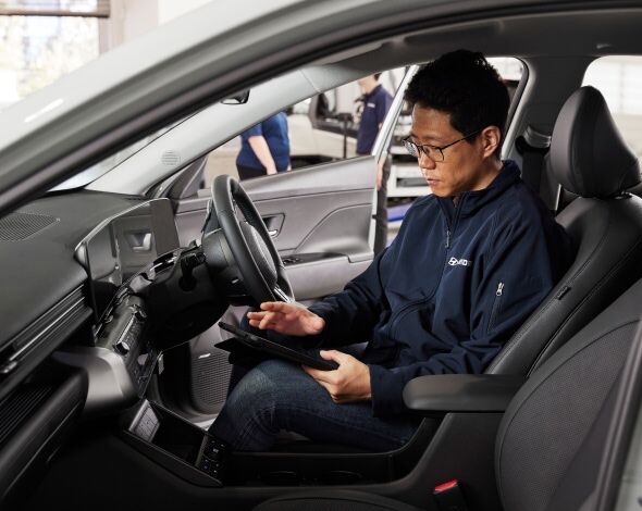 A Hyundai technician is testing the car.
