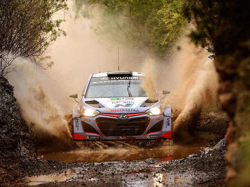Hyundai race car driving through muddy water 