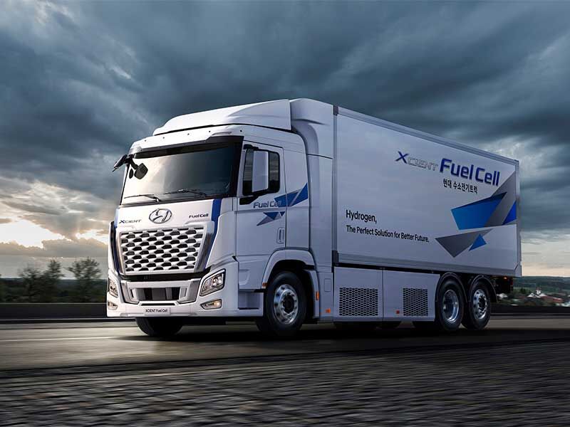 White Hyundai XCIENT Fuel Cell truck on road