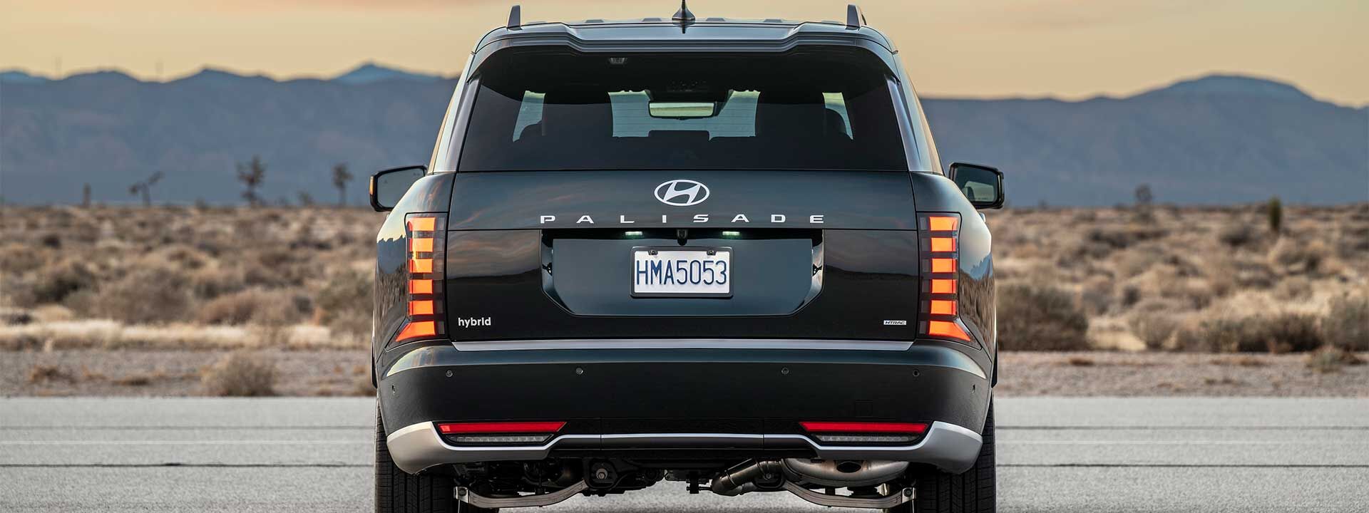 Rear view of the 2026 Hyundai Palisade Hybrid SUV parked on a desert road