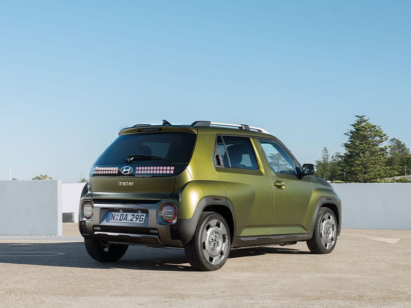 Hyundai Inster SUV in green and black, featuring circular headlights and LED strip,compact, bold, and urban-ready