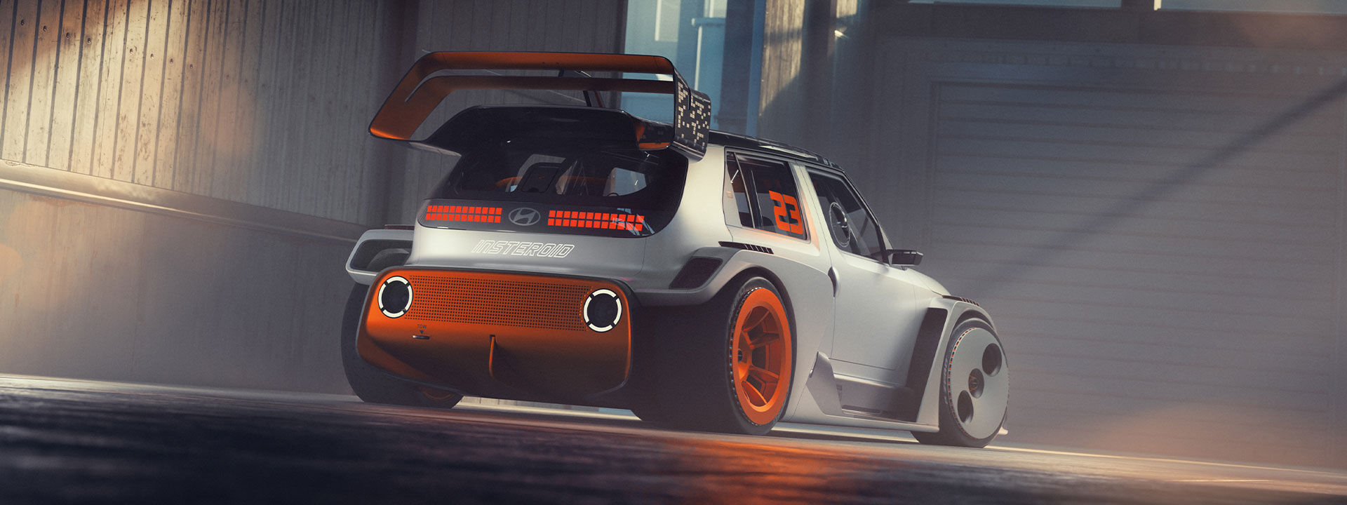 Rear view of the INSTERoid concept car, featuring a futuristic design with a large rear wing, bold orange accents, and the number 23 on the side window