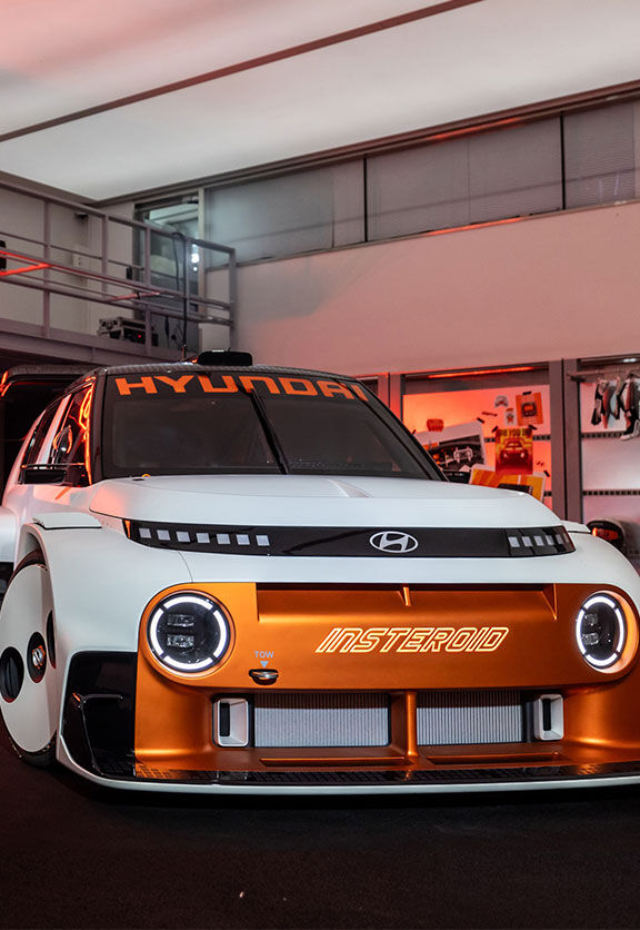 The Hyundai INSTEROID Concept Car showcases a futuristic motorsport vision with retro-inspired styling, bold orange accents, and a high-performance electric design built to turn heads.