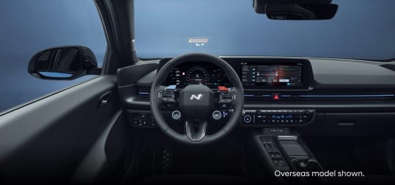 A wide-angle interior view of the Hyundai Ioniq 6 N's dashboard, steering wheel, and infotainment system  3 of 4 assets 