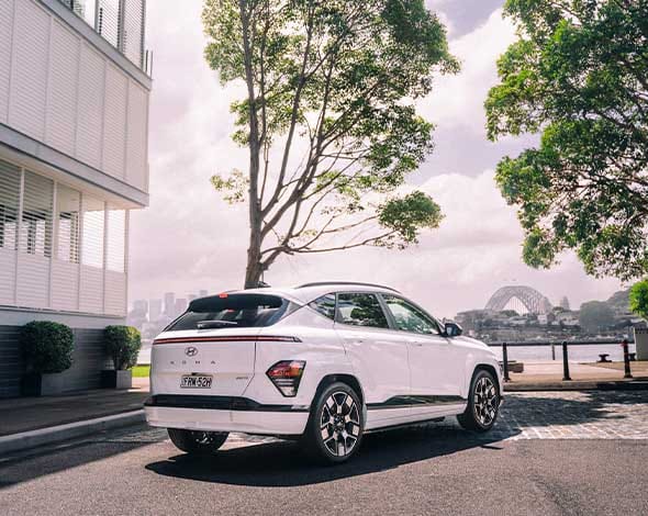 Hyundai KONA Electric in white with the harbour bridge as the backdrop