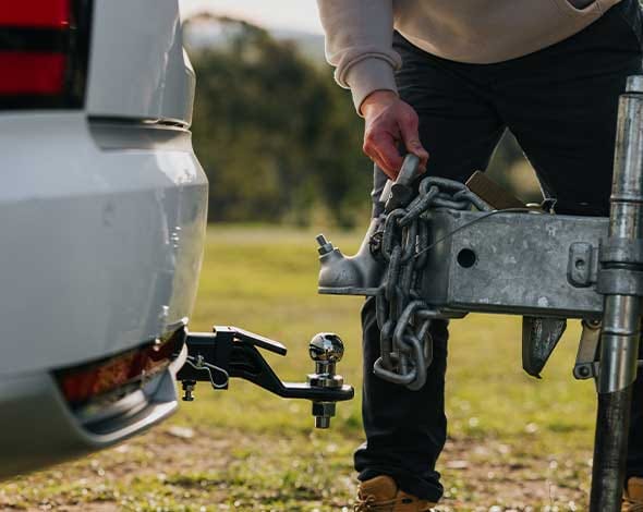 Close-up of a Hyundai towbar and caravan coupling connection, demonstrating secure towing setup, safety features, and genuine Hyundai towing accessories for adventure-ready travel.