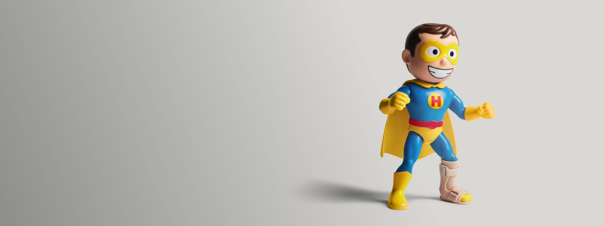Smiling superhero figurine with a leg brace, featured in Hyundai Help for Kids’ partnership with Kids Research Institute, symbolizing resilience, innovation, and the power of medical research to transform young lives.