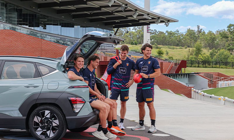 Hyundai KONA parked at a Brisbane Lions training facility, showcasing Hyundai’s partnership with the club and commitment to supporting Australian sport.