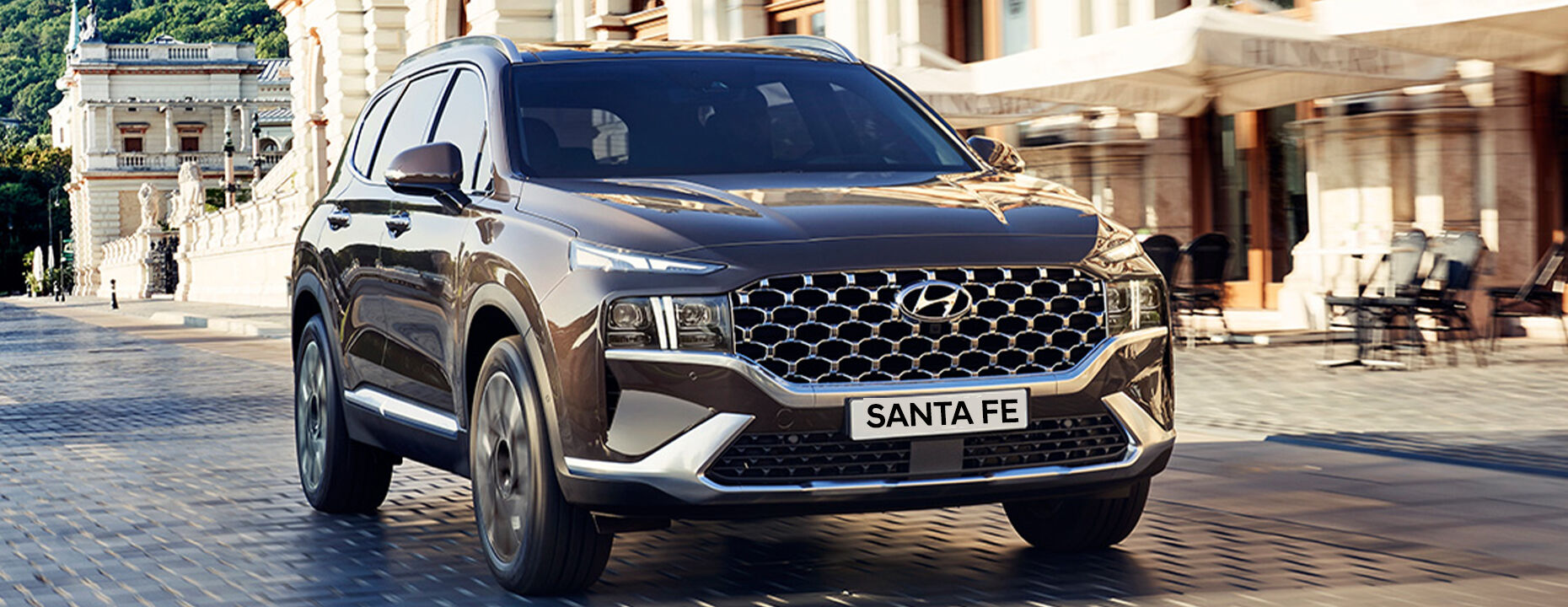 A brown Santa Fe driving along street
