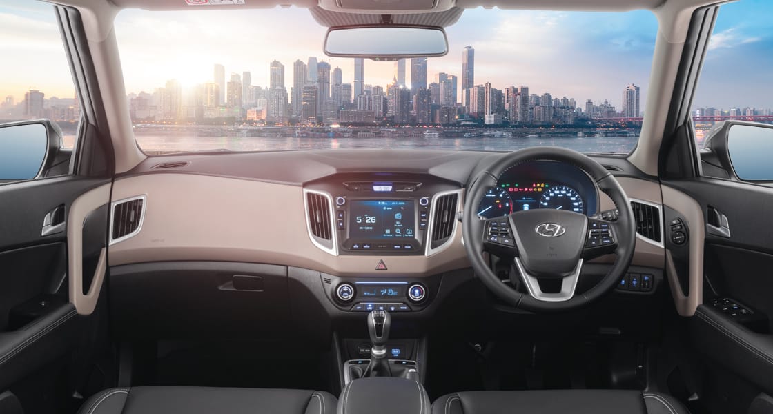 Front view of driving blue Elantra on the road in the city