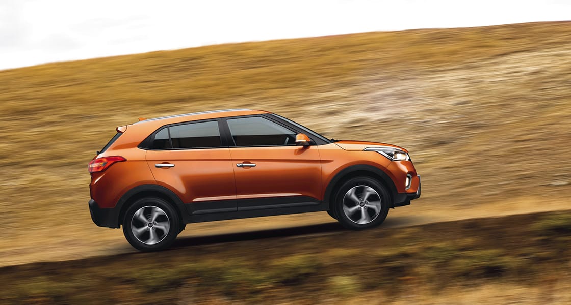 Right side rear view of silver Elantra parked in front of the building