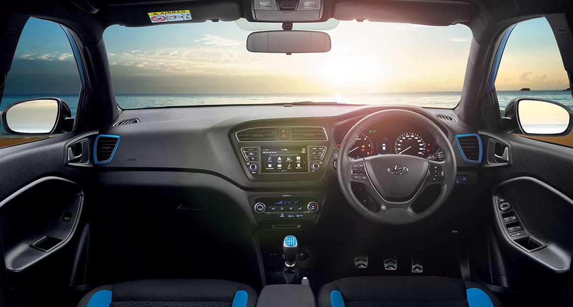 Front view of driving blue Elantra on the road in the city