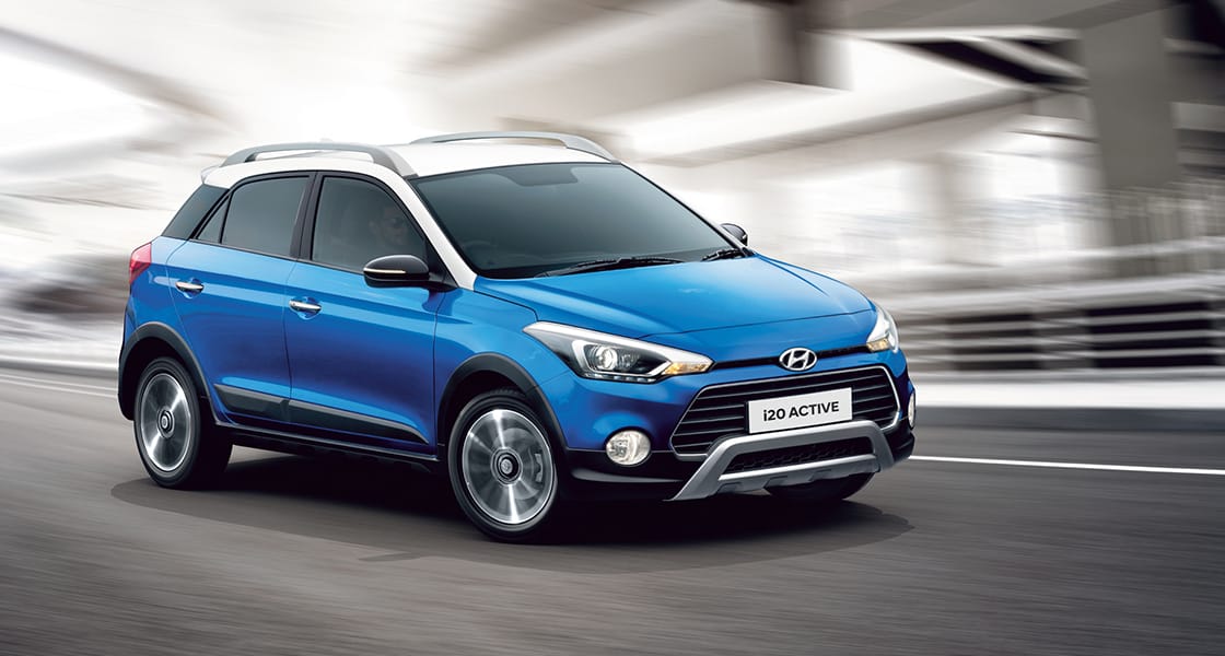 Side rear view of silver Elantra driving on the road in the city