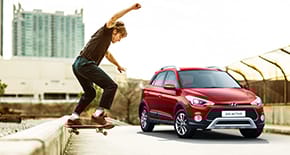 Right side rear view of silver Elantra parked in front of the building