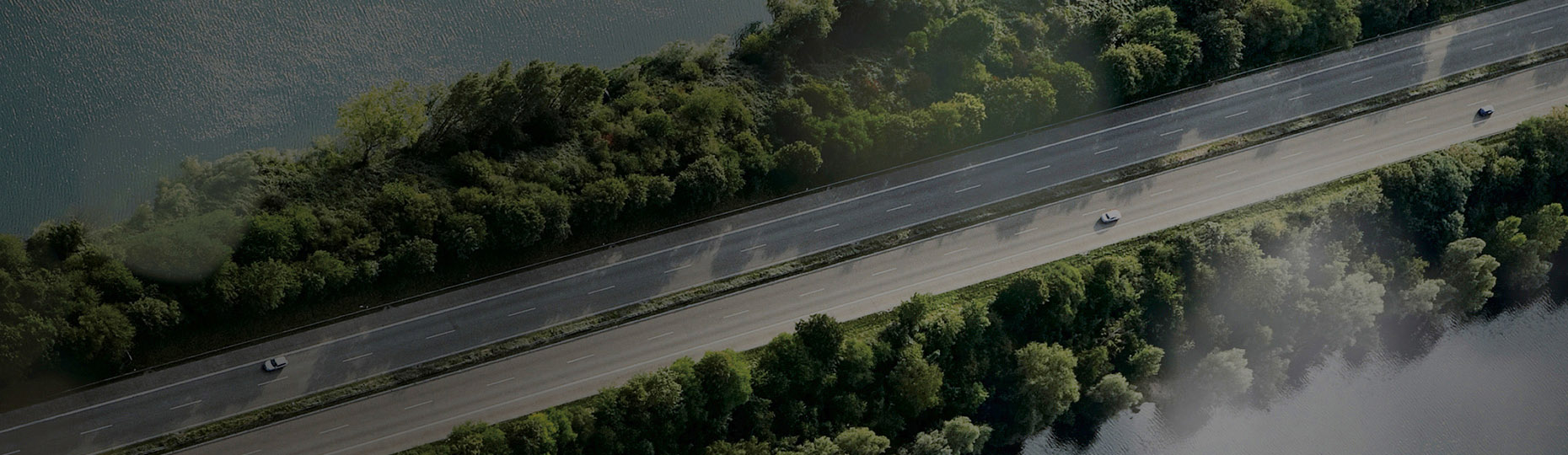 a car that runs on the road with open seas on both sides