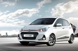 Side front view of tangerine orange Grand i10