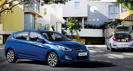 Right side rear view of silver Elantra parked in front of the building