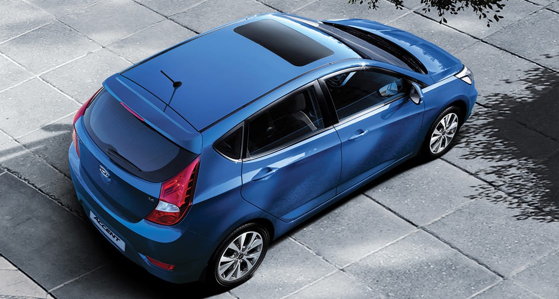 Top view of blue Accent5DR parked on the asphalt road