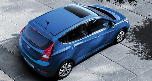 Top view of blue Accent5DR parked on the asphalt road