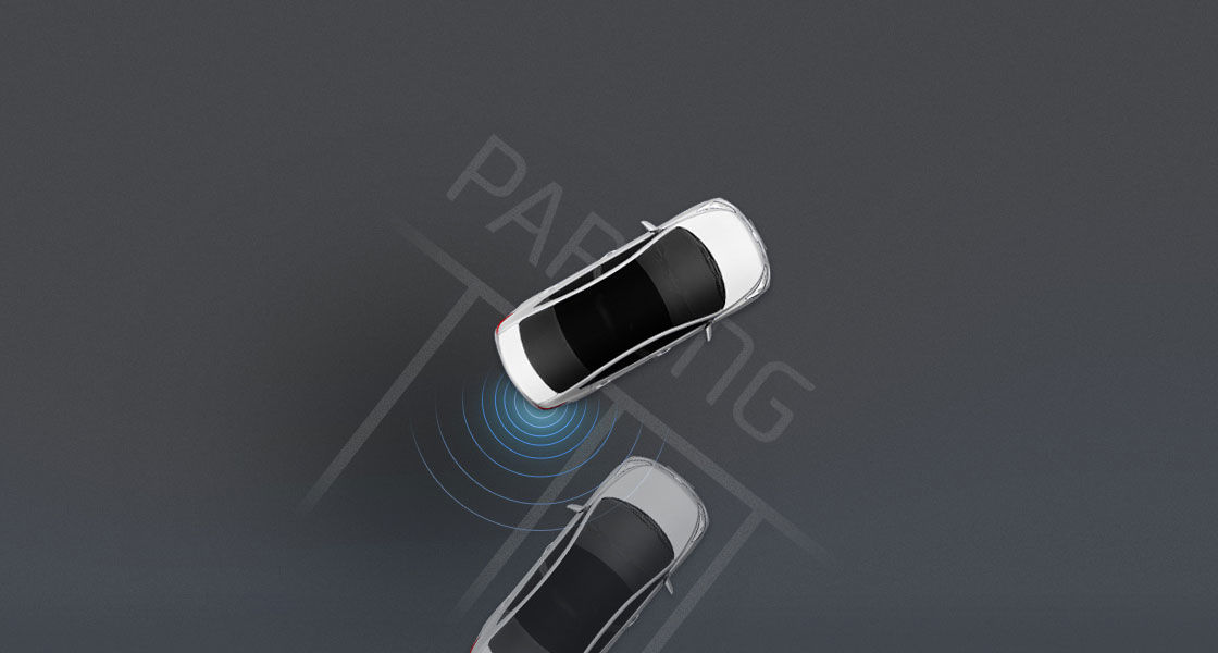 Top view of white Accent parking with rear parking assist system