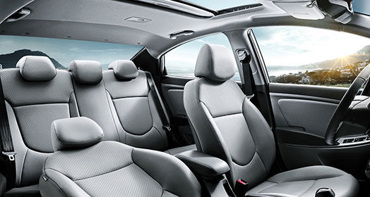 Panoramic view of interior with front passenger's seat lean back and sunroof opened