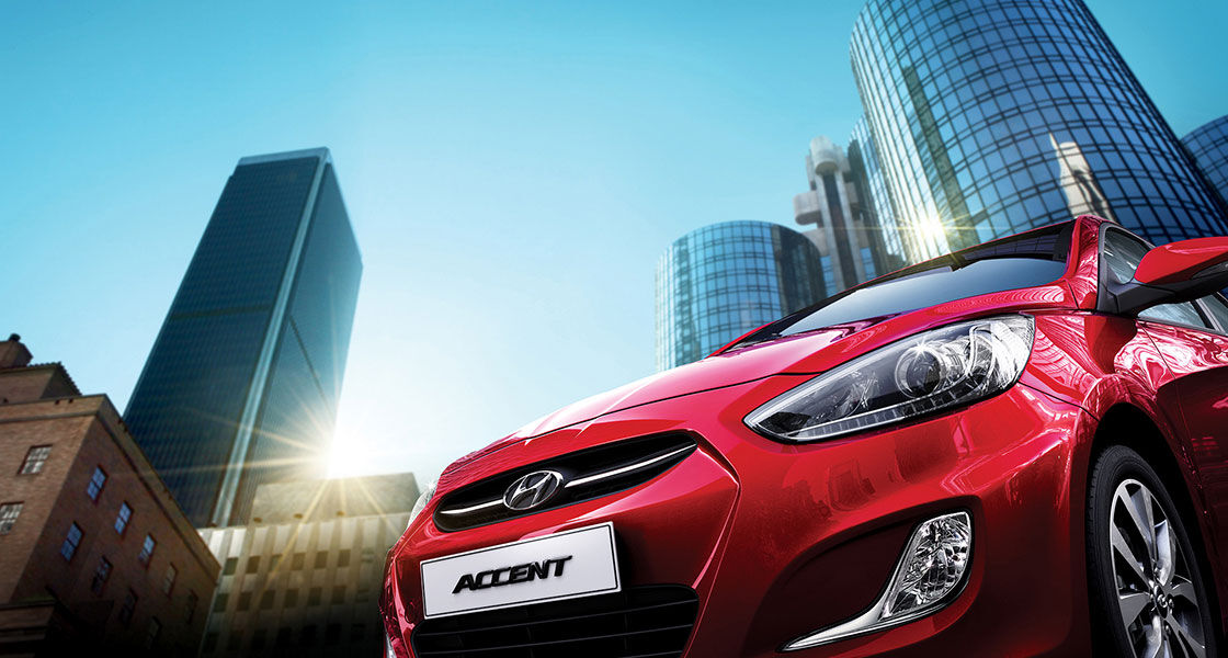 Low view of front red Accent with city towers as a background