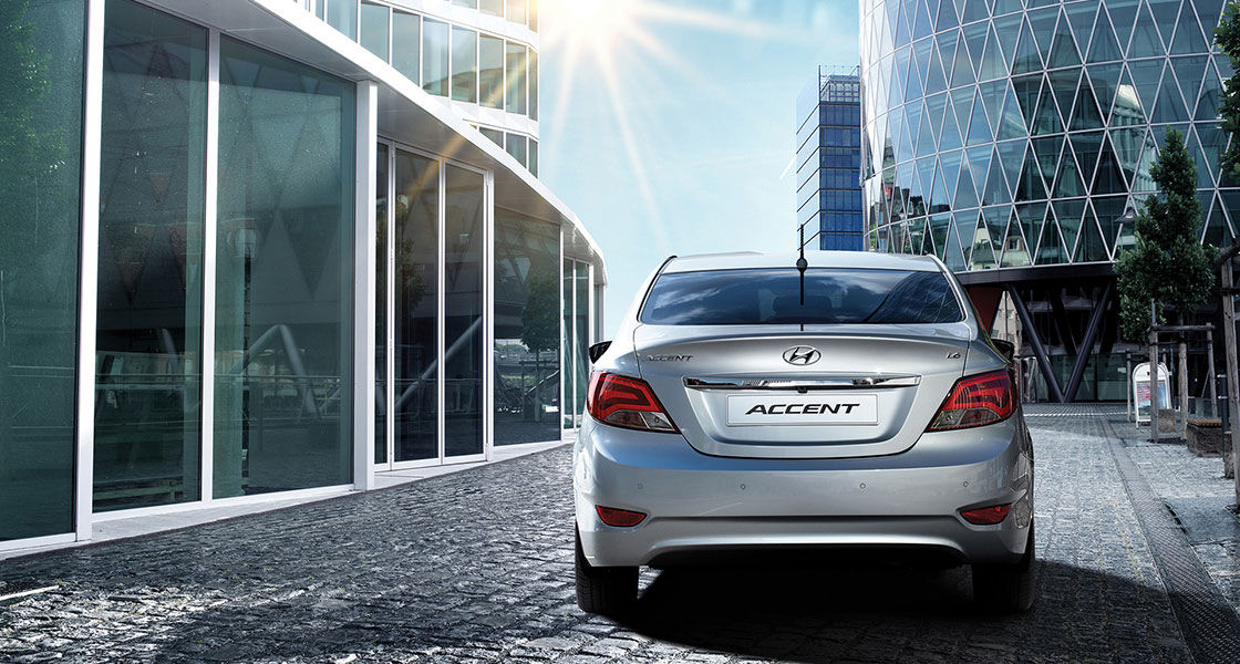 Rear view of silver Accent driving