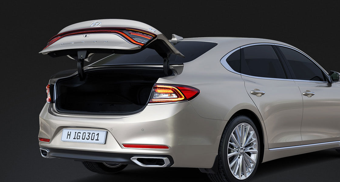 Rear view of luminous beige Azera with trunk door opened