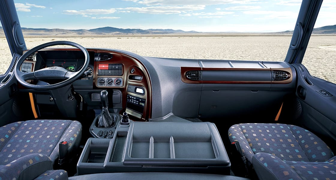 inside of truck's cockpit with wide dessert view