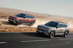 Two all-new Hyundai TUCSON models driving side by side, one on an open road and the other across dusty off-road terrain.