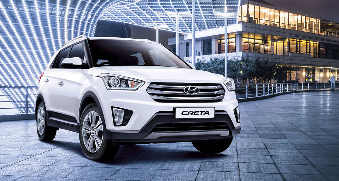 Right side-front view of white creta parked in front of the building
