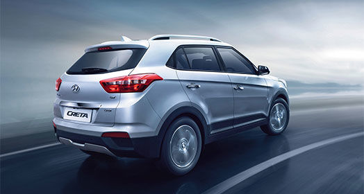 Right side rear view of driving silver creta on the road