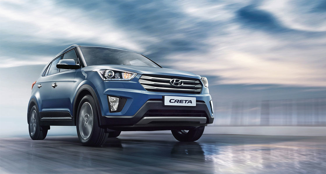 Side front view of navy Creta driving on a cloudy day