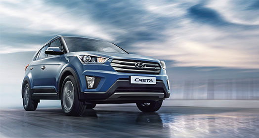 Side front view of navy Creta driving on a cloudy day