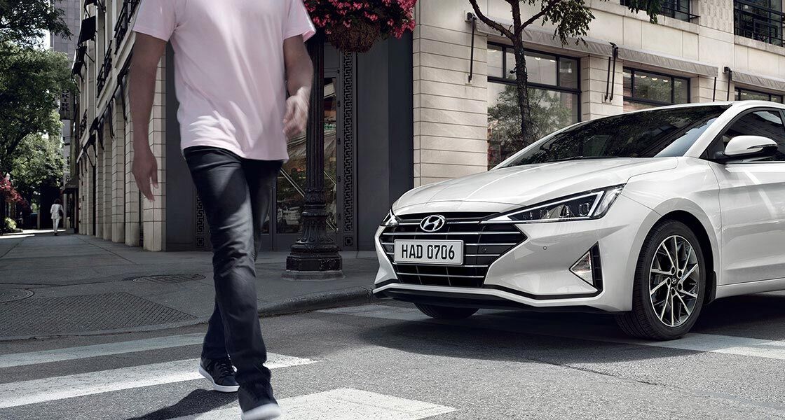 elantra 2019 with man walking on sidewalk