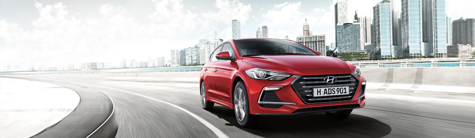 Red color Elantra Sport is driving on the urban road