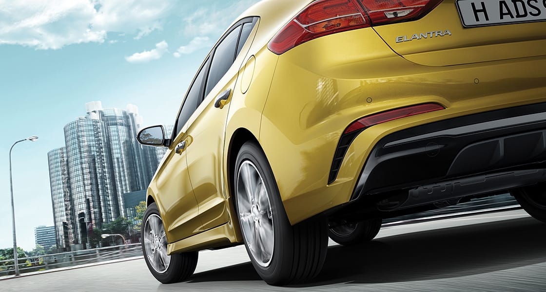 Low view of yellow Elantra Sport driving to the city