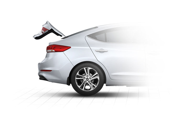Side view of silver Elantra with trunk door opened