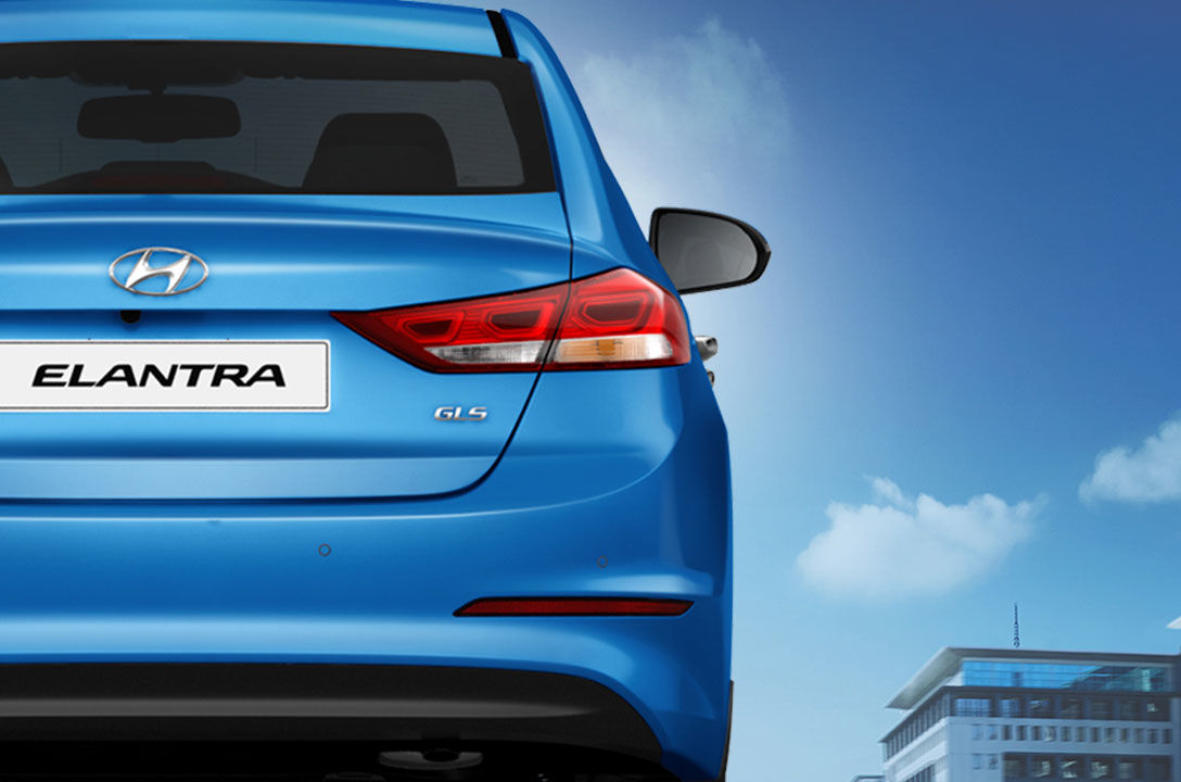 Rear view of blue Elantra on a sunny day