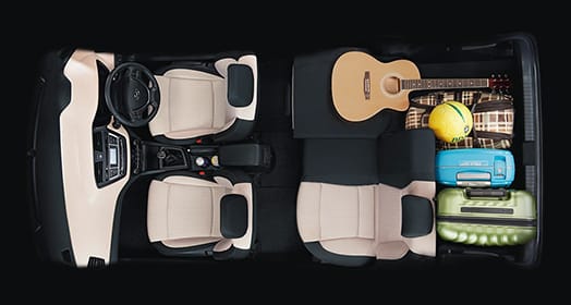 Sky view of interior with many luggage and guitar stored at the back