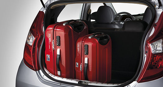 Two red luggage loaded on the trunk